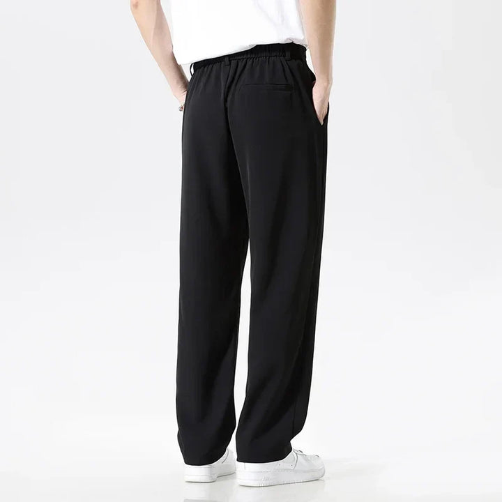 Black men's relaxed fit formal pants, suitable for business meetings or elegant casual outfits. Versatile.