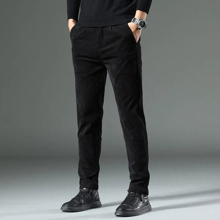 Black men's relaxed fit corduroy pants, offering classic comfort and casual style.