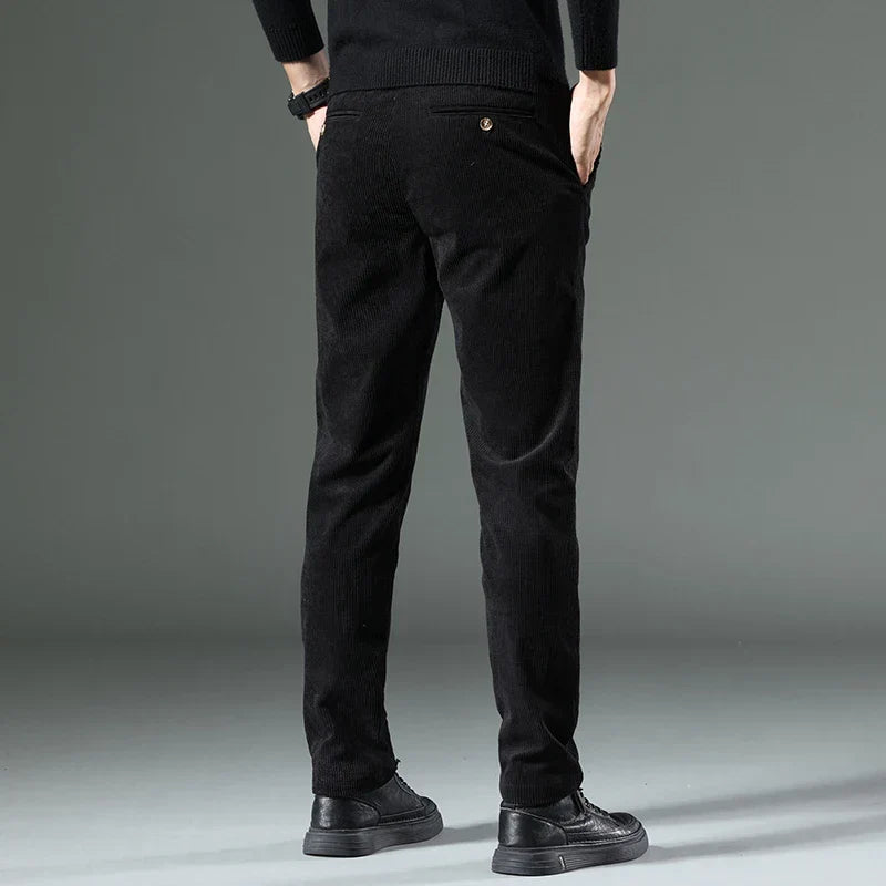 Detailed shot of men's relaxed fit corduroy trousers, emphasizing their comfortable design.