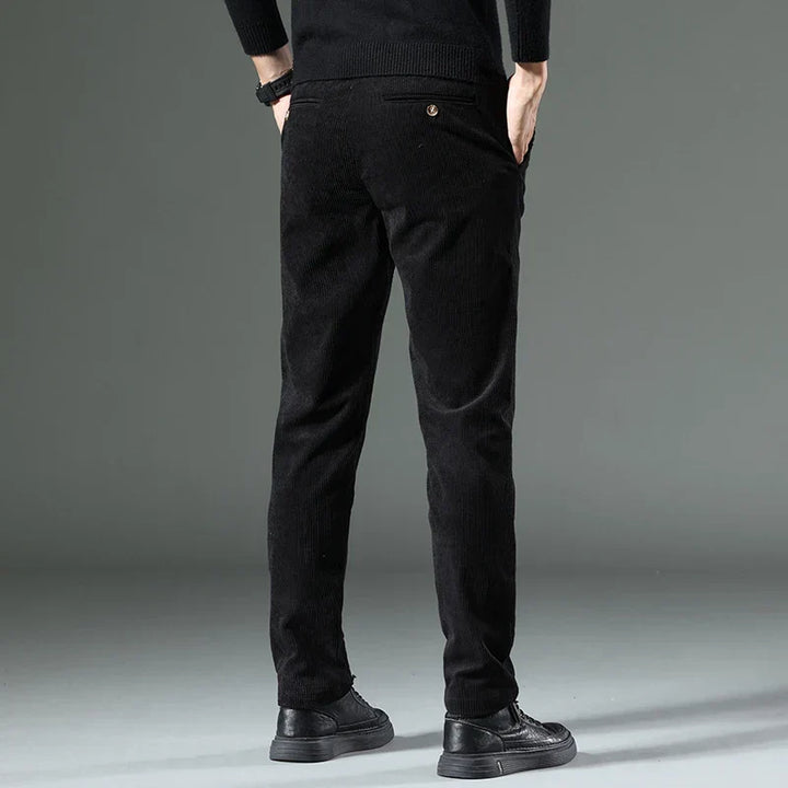 Detailed shot of men's relaxed fit corduroy trousers, emphasizing their comfortable design.