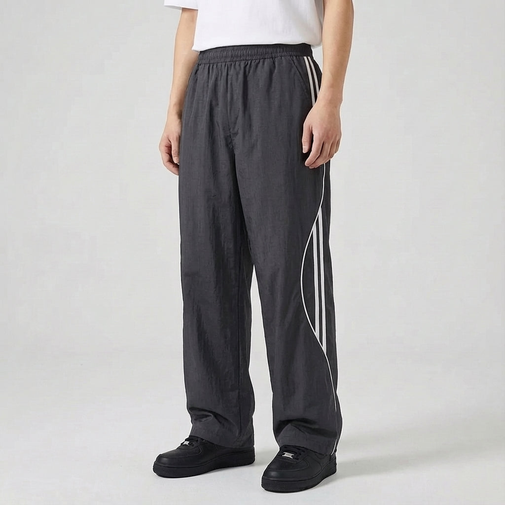 Trendy men's loungewear joggers, dark blue with an athletic side stripe design, combining comfort and style.