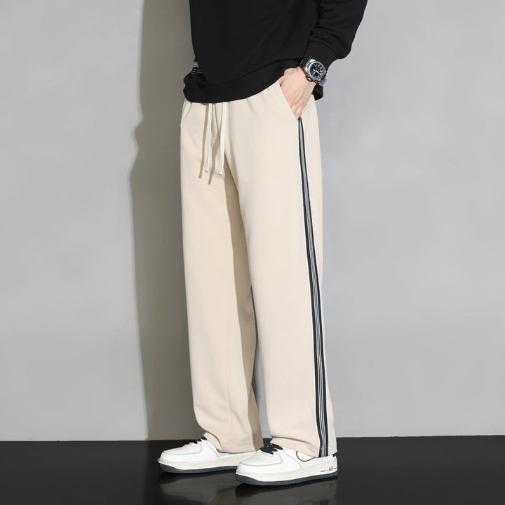 Comfortable men's polyester relaxed fit joggers. Features straight leg & athletic side stripe, perfect for lounge or sport.