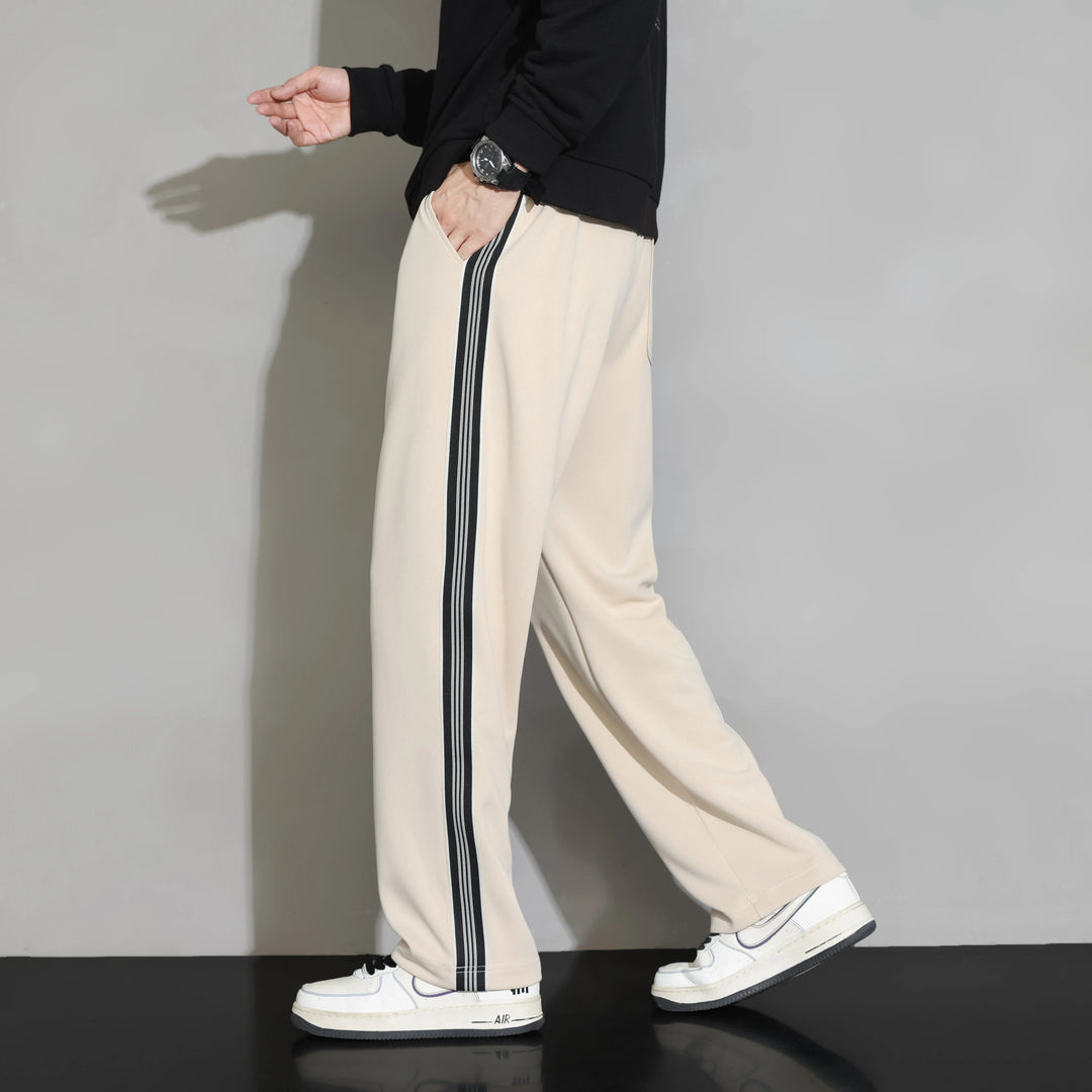 Stylish men's casual joggers in a relaxed fit. Black design with a sporty side stripe for everyday comfort & activewear.