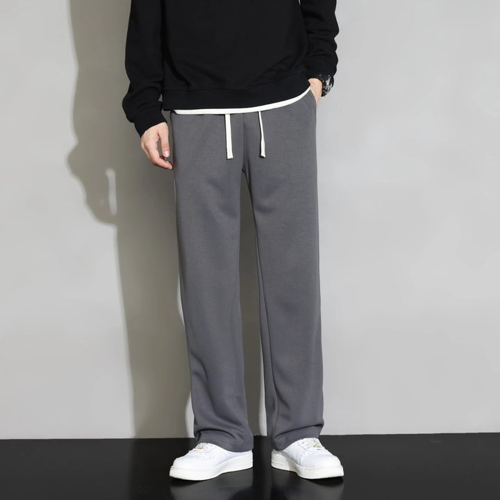 Men's relaxed fit athletic joggers. Black with contrasting sporty side stripe, drawstring waist & straight leg. Everyday wear.