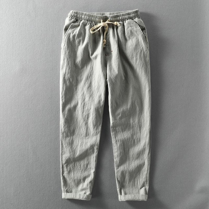 Stylish men's linen trousers with a relaxed fit, ideal for casual summer fashion. Features a practical drawstring waist.