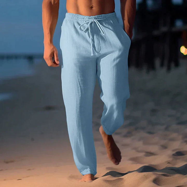 Men's relaxed fit linen trousers in natural color with drawstring waist, ideal for summer.