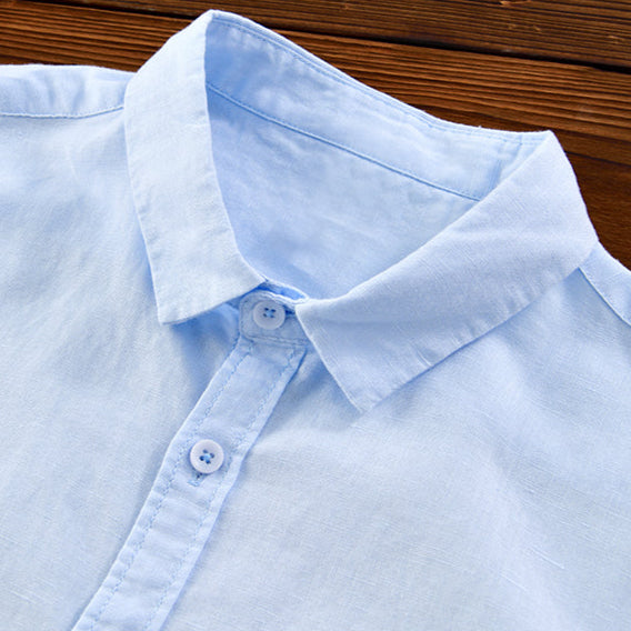 Man wearing a relaxed fit long sleeve button-down shirt, styled casually for warm weather.