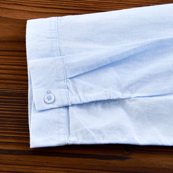 Close-up of lightweight, breathable fabric on a men's relaxed fit button-down shirt, ideal for summer.
