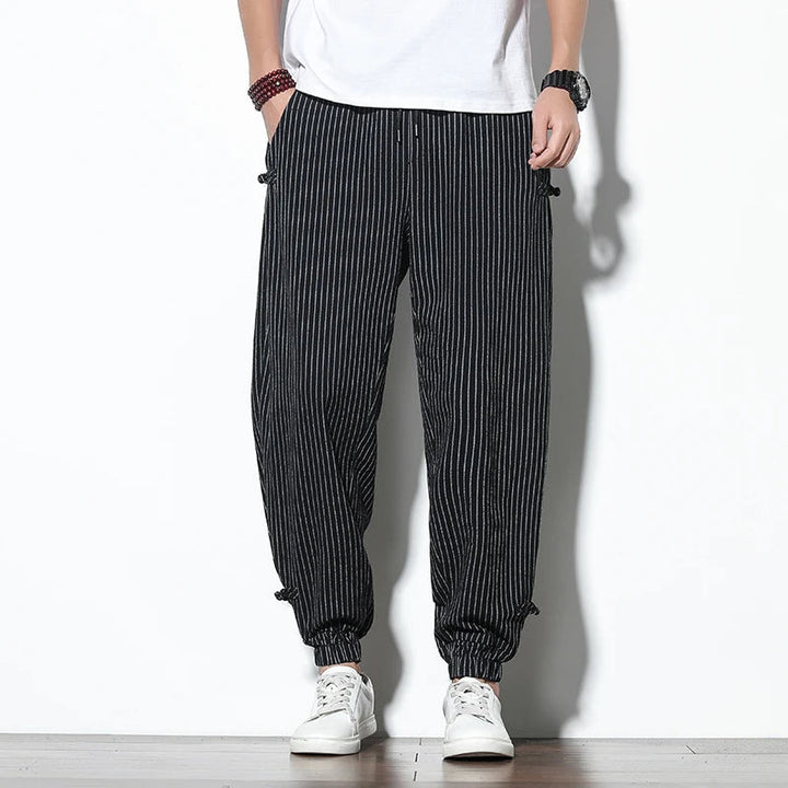Drawstring waist men's pinstripe pants, offering comfortable relaxed fit for casual and active wear.