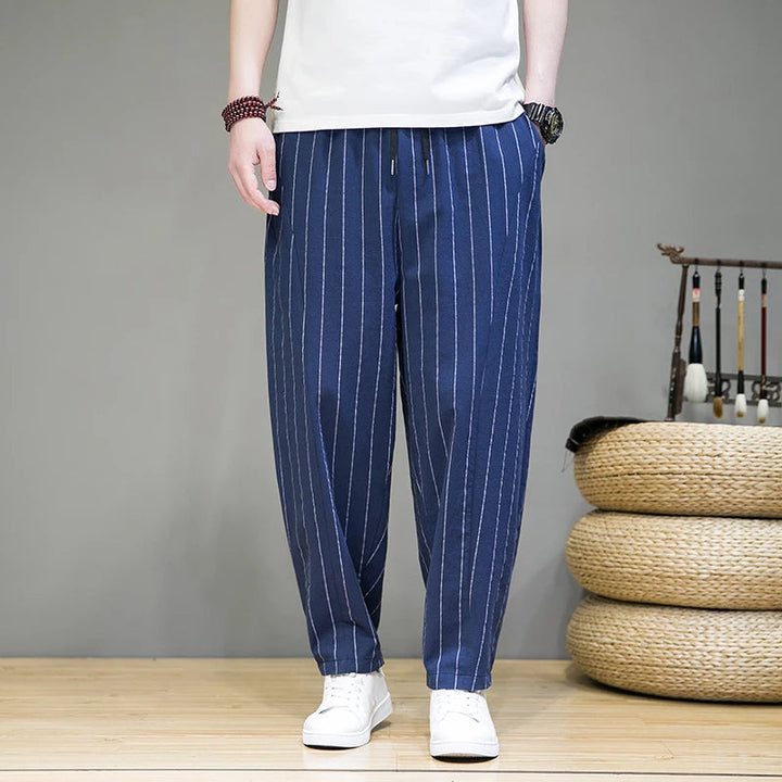 Stylish men's pinstripe lounge pants, relaxed wide-leg fit with drawstring, ideal for casual comfort & fashion.