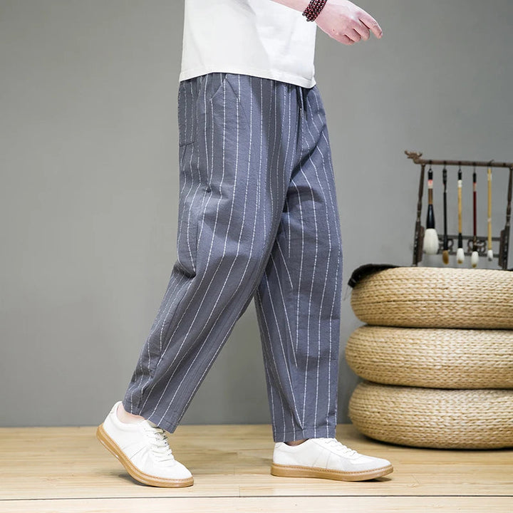 Men's casual pinstripe lounge pants with relaxed wide leg and drawstring, a comfortable and fashionable choice.