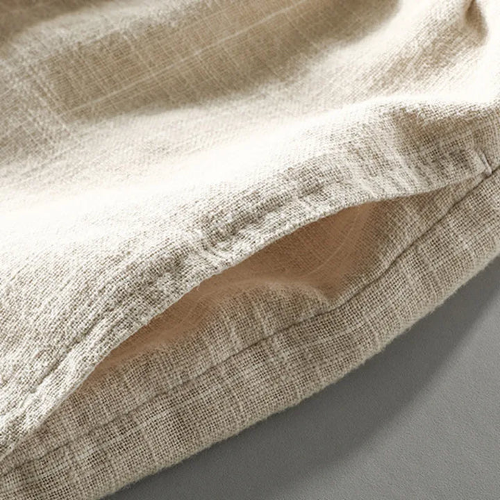 Closeup of men's relaxed pinstripe summer shorts, showcasing fabric texture, elastic waist, & drawstring.