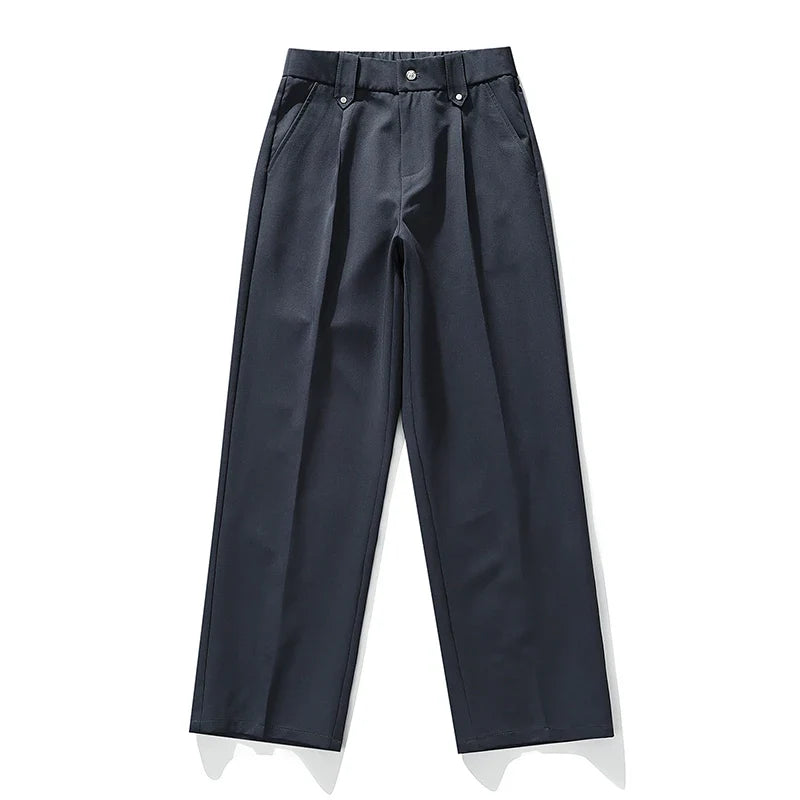 Detail shot: Men's relaxed fit pleated dress trousers, highlighting fabric, pleats, & modern comfort features.