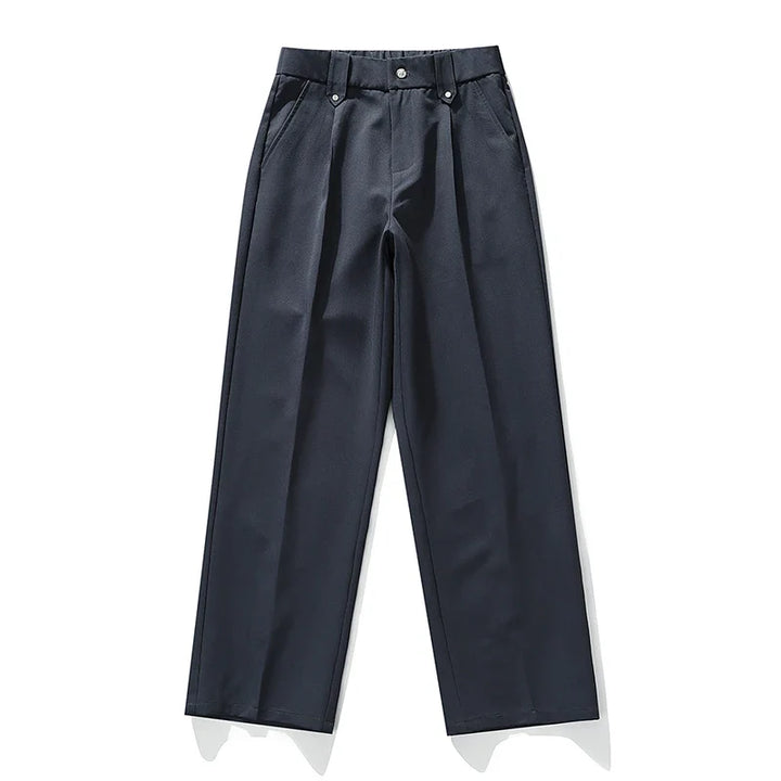 Detail shot: Men's relaxed fit pleated dress trousers, highlighting fabric, pleats, & modern comfort features.