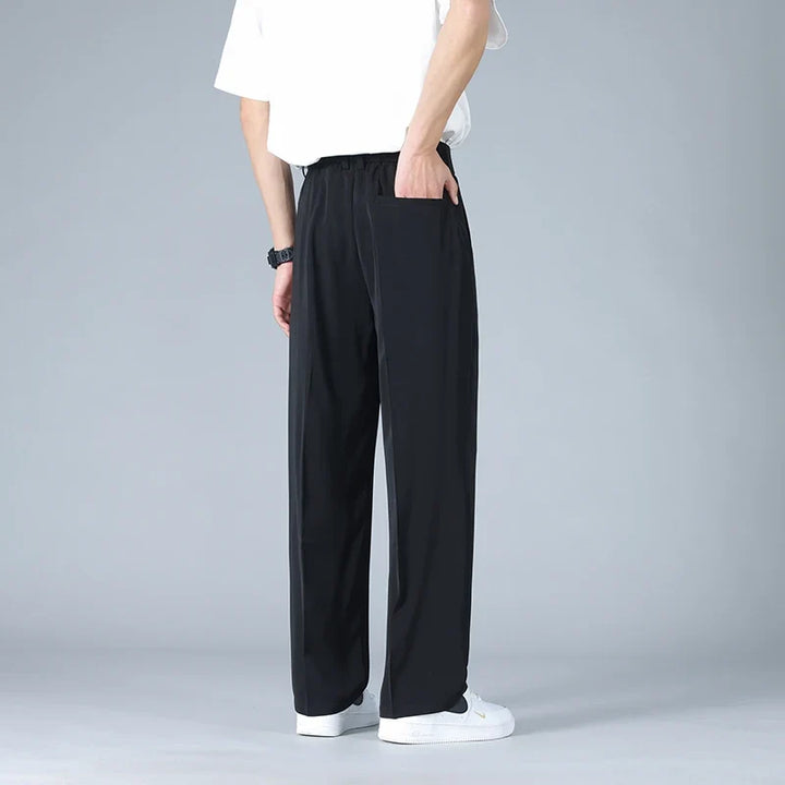 Comfortable men's relaxed fit pleated dress trousers, perfect for all-day modern wear & workday outfits.