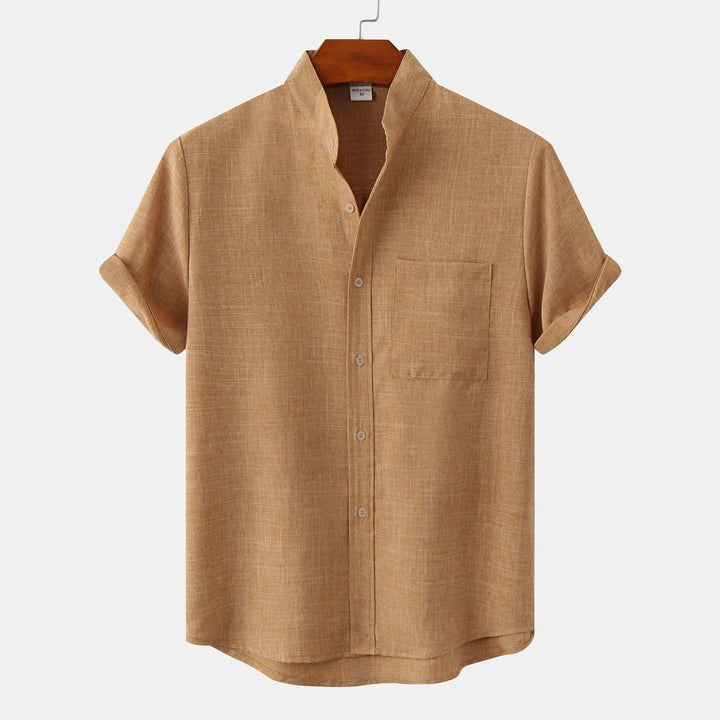 White relaxed fit short sleeve men's shirt, stand collar, ideal for warm weather comfort.