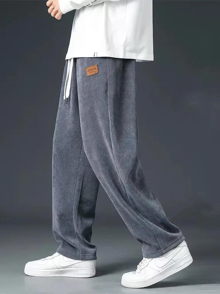Close-up of men's casual straight-leg pants featuring a comfortable elastic waist and functional drawstring.