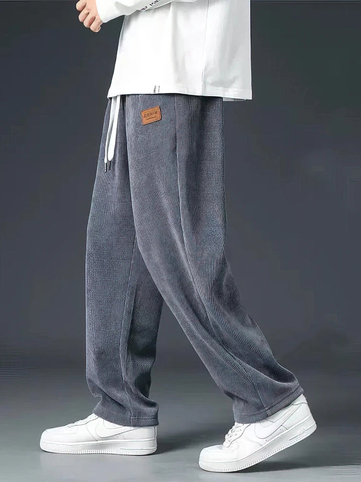 Close-up of men's casual straight-leg pants featuring a comfortable elastic waist and functional drawstring.