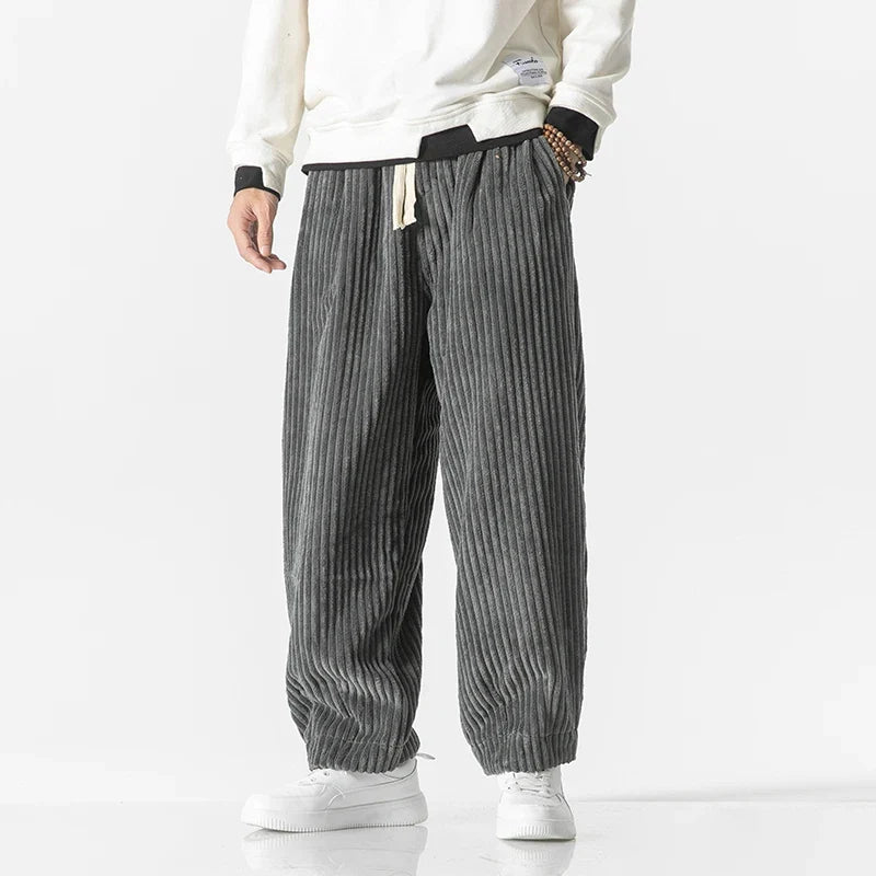 Model wearing men's relaxed fit stylish trousers, demonstrating their comfortable fit & modern casual look.