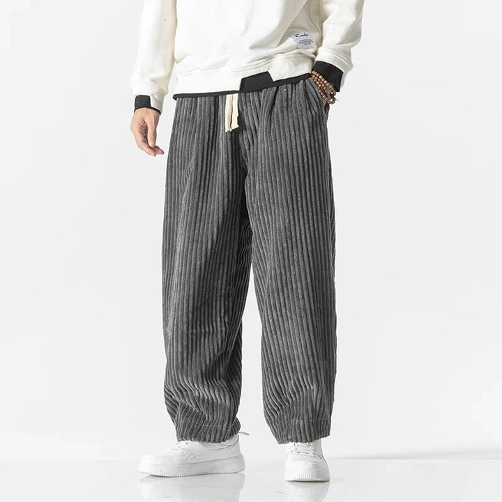 Model wearing men's relaxed fit stylish trousers, demonstrating their comfortable fit & modern casual look.