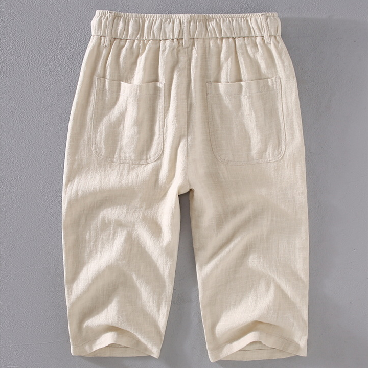 Comfortable men's mid-thigh summer shorts with drawstring waist, ideal for beachwear or vacation.