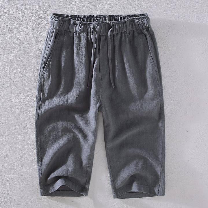 Relaxed fit men's mid-thigh shorts, perfect casual wear for summer, vacation, or beach days.