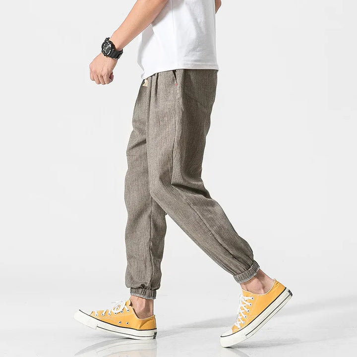 Modern men's relaxed fit tapered joggers with elastic waist & drawstring for versatile athleisure style.