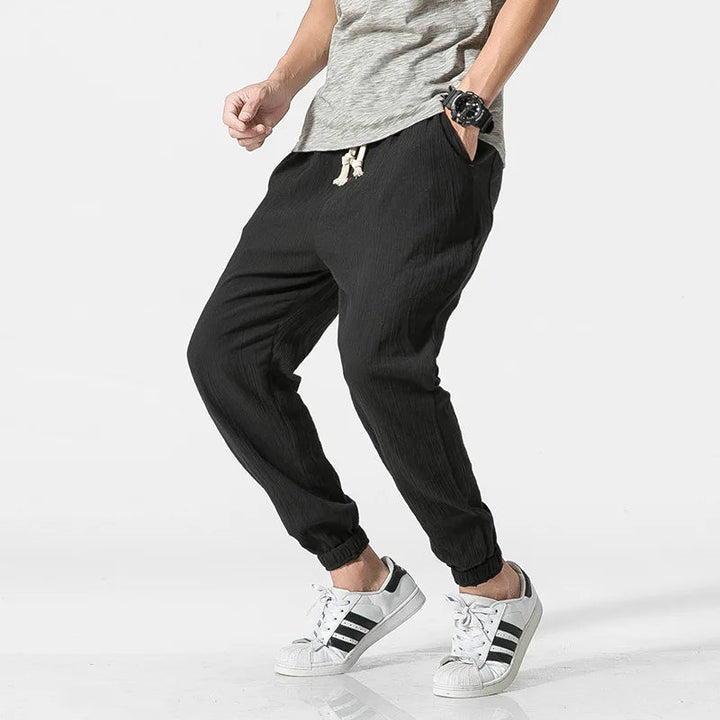 Comfortable men's tapered joggers with elastic waist & drawstring, ideal for loungewear & active days.