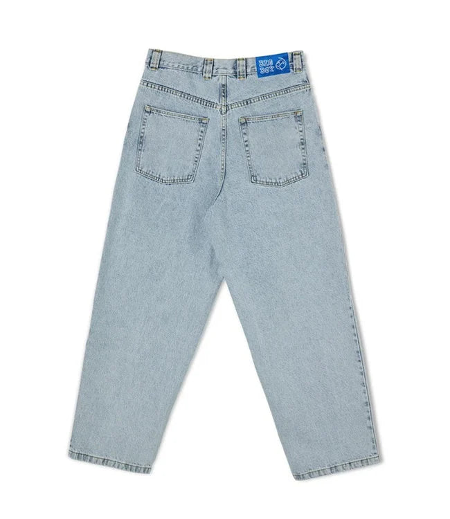 Man sitting, wearing comfortable relaxed fit jeans, perfect for skate and urban fashion.