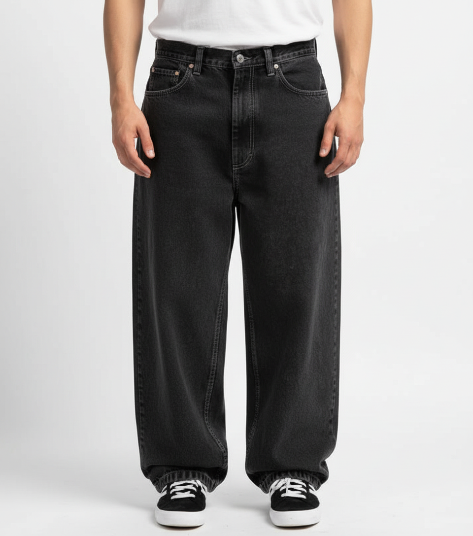 Close-up of knee area on relaxed fit jeans, showing denim texture and urban style.