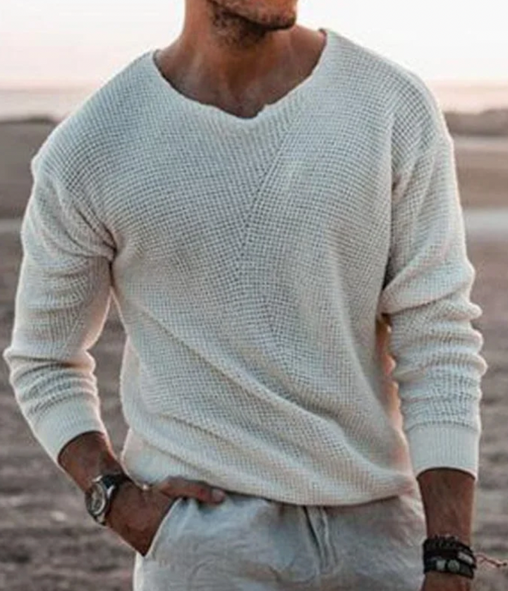 Close-up of the cozy men's waffle-knit long-sleeve sweater texture, highlighting comfortable fabric.