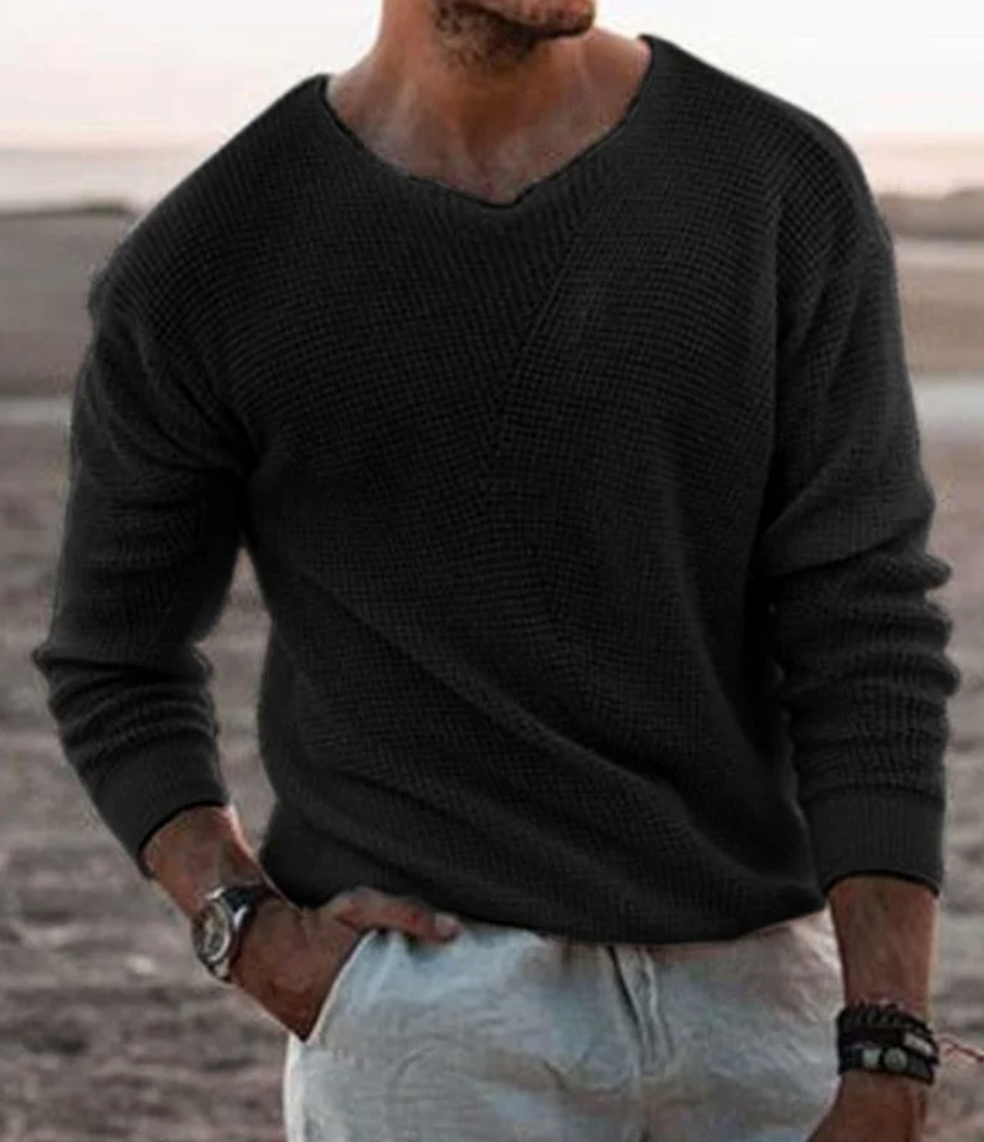 Man wearing a stylish relaxed fit waffle-knit long-sleeve sweater, ideal for everyday casual wear.