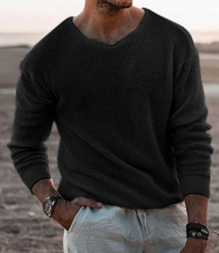 Man wearing a stylish relaxed fit waffle-knit long-sleeve sweater, ideal for everyday casual wear.