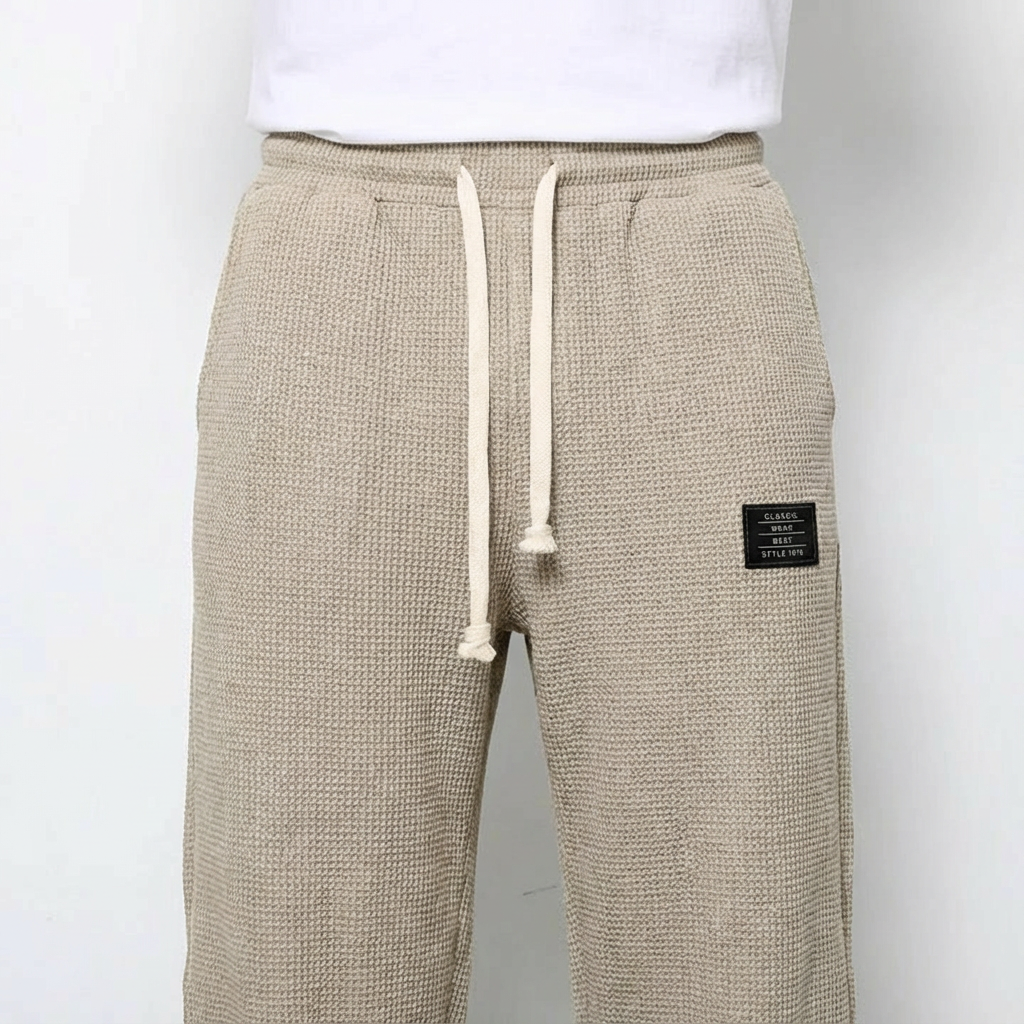 Comfortable men's drawstring pants, relaxed fit waffle knit, ideal for loungewear.