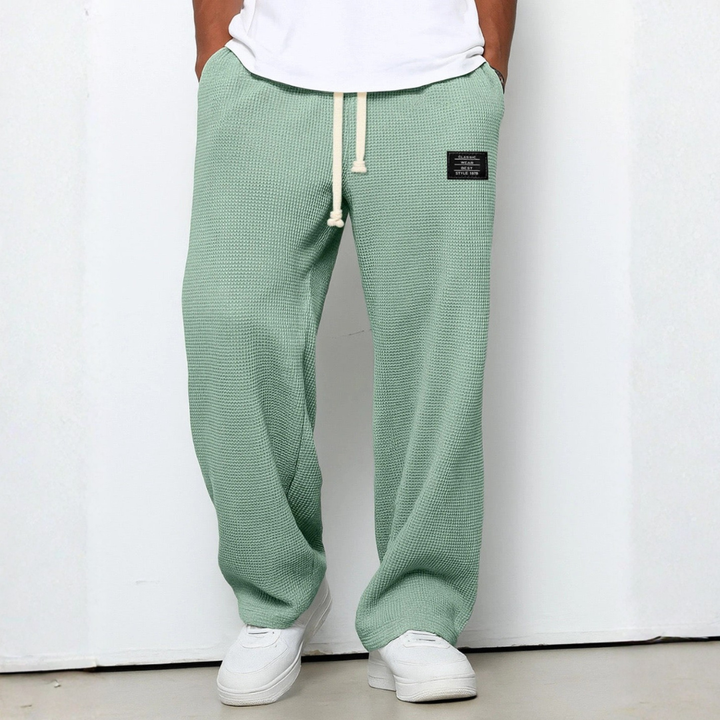 Men's relaxed fit knit pants with a waffle texture, great for comfort and casual style.