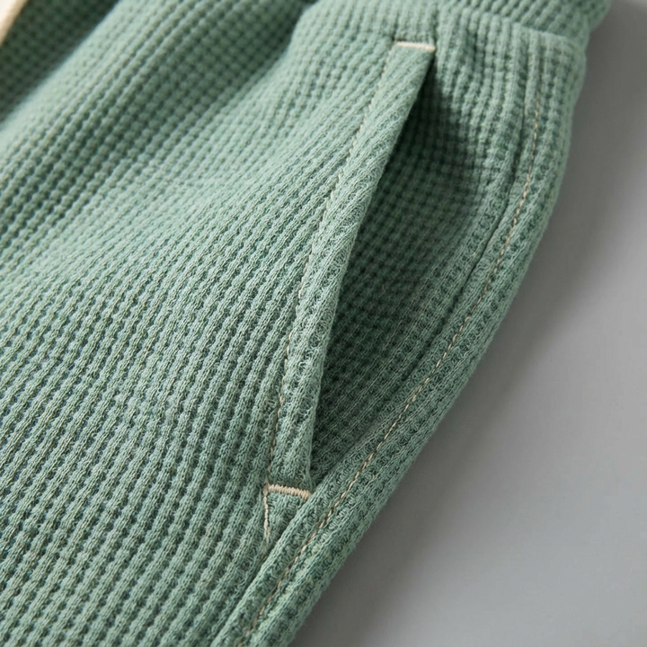 Versatile men's loungewear: relaxed fit waffle knit trousers for ultimate comfort.
