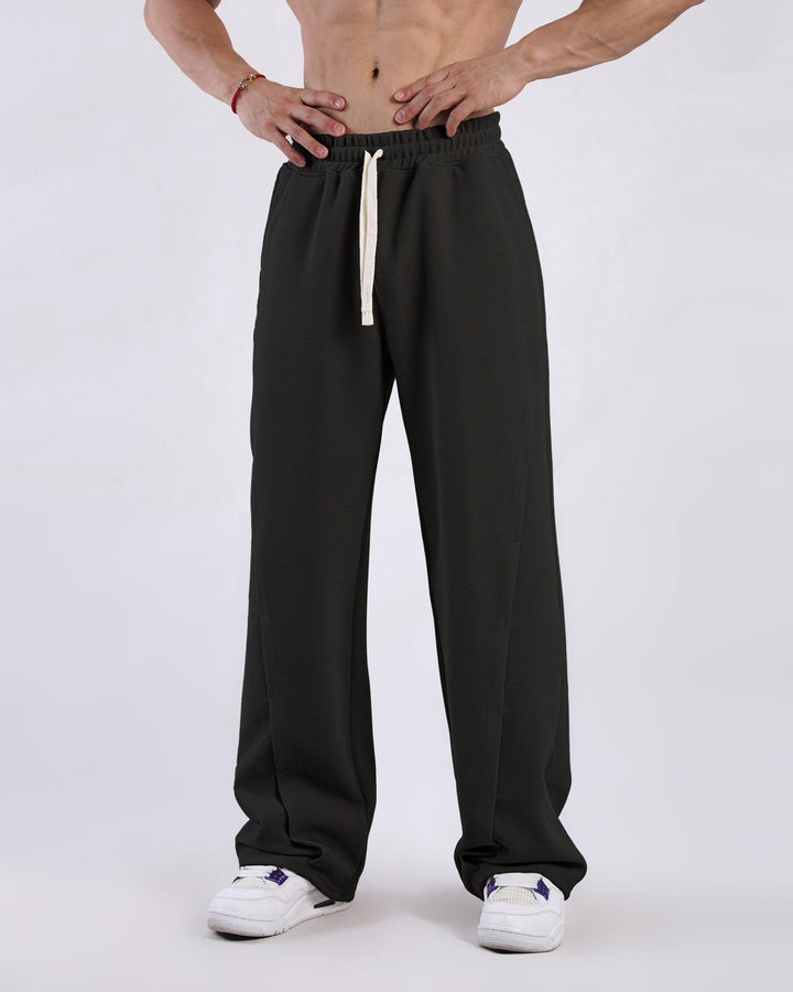 Close-up of men's relaxed waffle sweatpants fabric, showcasing texture, ideal for loungewear & casual style.