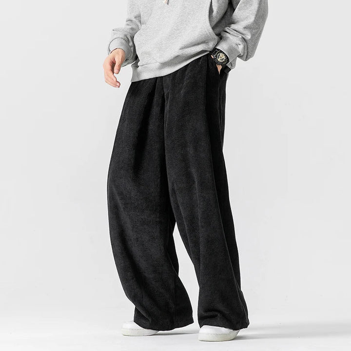 Navy blue men's wide-leg pants, relaxed fit. Drawstring waist for comfort, great for casual or 90s style.