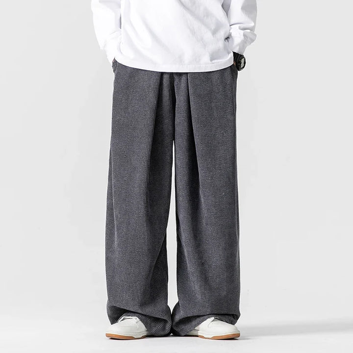 Black men's relaxed fit wide-leg pants. Drawstring waist for comfort, great for versatile casual & 90s style.