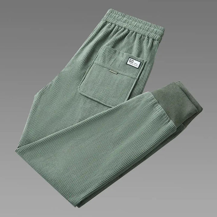 Man models men's relaxed ribbed joggers, showcasing their comfortable tapered fit and versatile casual style.