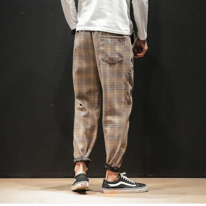 Detailed view of the classic plaid pattern on Renegade men's stylish, comfortable trousers.