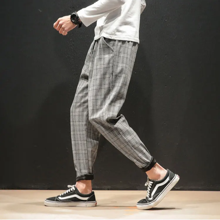 Full-length shot of men's tapered plaid trousers, showcasing modern fit and comfortable design.