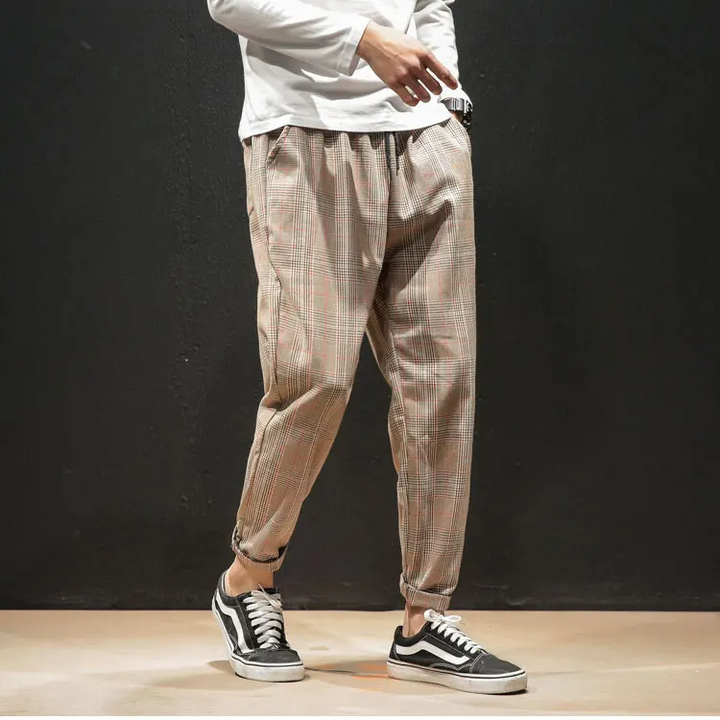 Modern men's apparel: comfortable, stylish plaid bottoms with stretch and a versatile tapered fit.