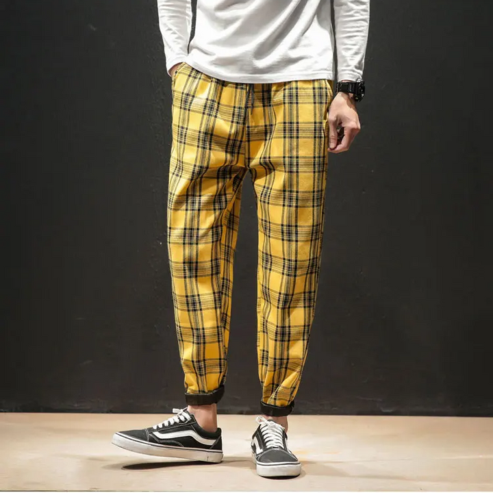 Stylish men's tapered plaid pants with a comfortable drawstring waist, perfect for everyday modern wear.
