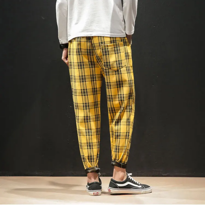Men's cuffed plaid trousers, blending modern style with stretch comfort for a sharp, versatile look.