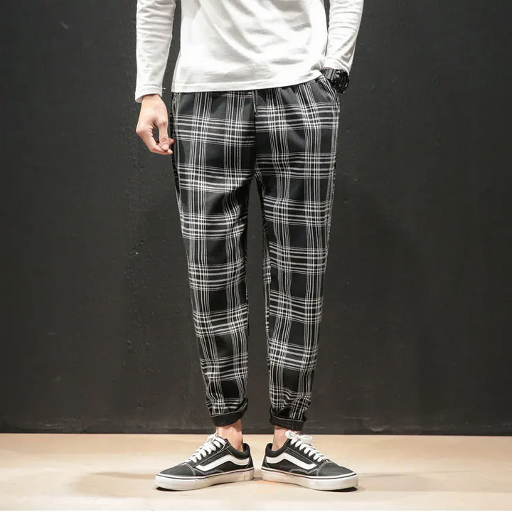Formal-ready men's plaid trousers: tapered, comfortable, and stylish for a sophisticated modern appeal.