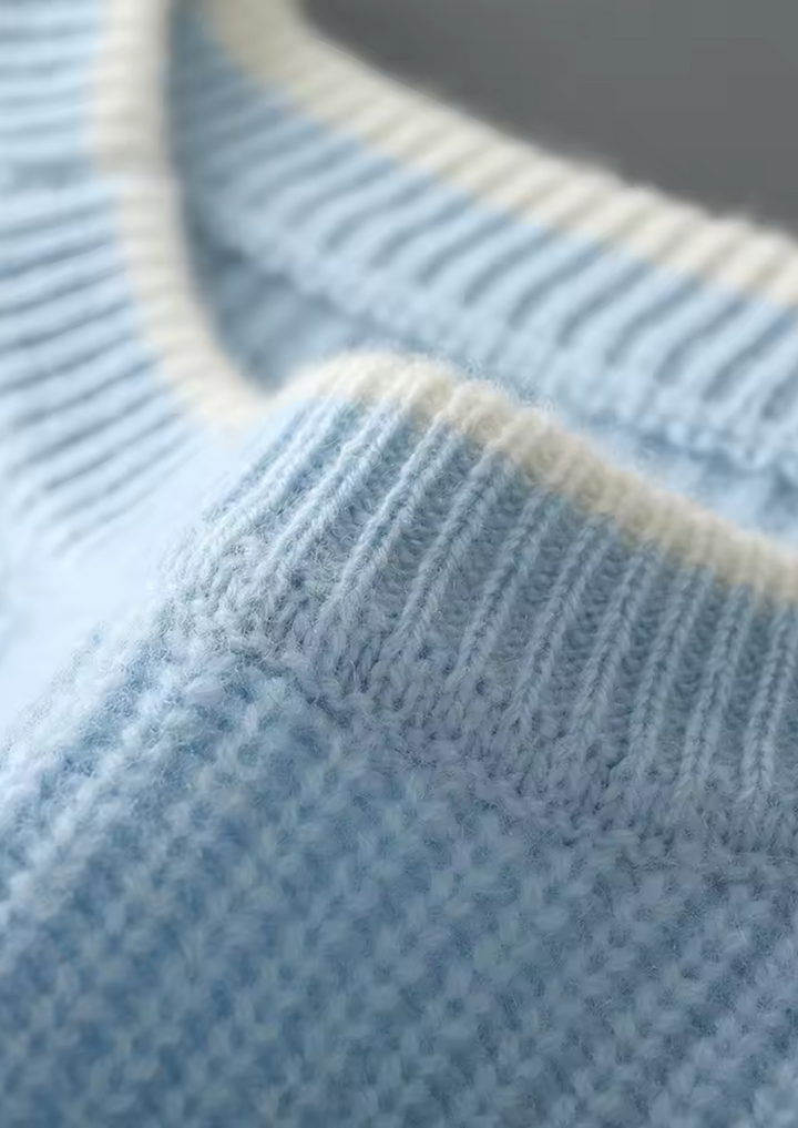 Close-up of the ribbed knit texture on a men's classic crew neck sweater. High quality detail.