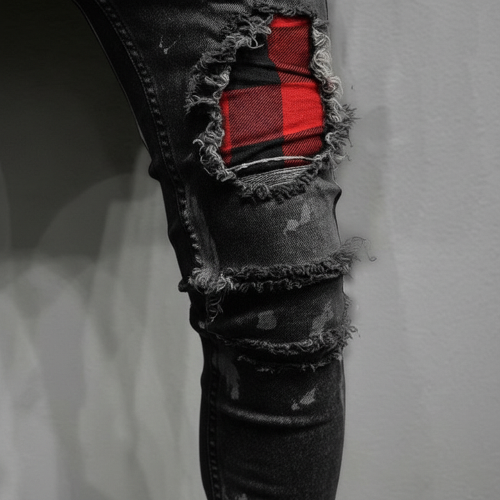 Full-length view of men's distressed slim fit jeans, featuring multiple patches & trendy rips.