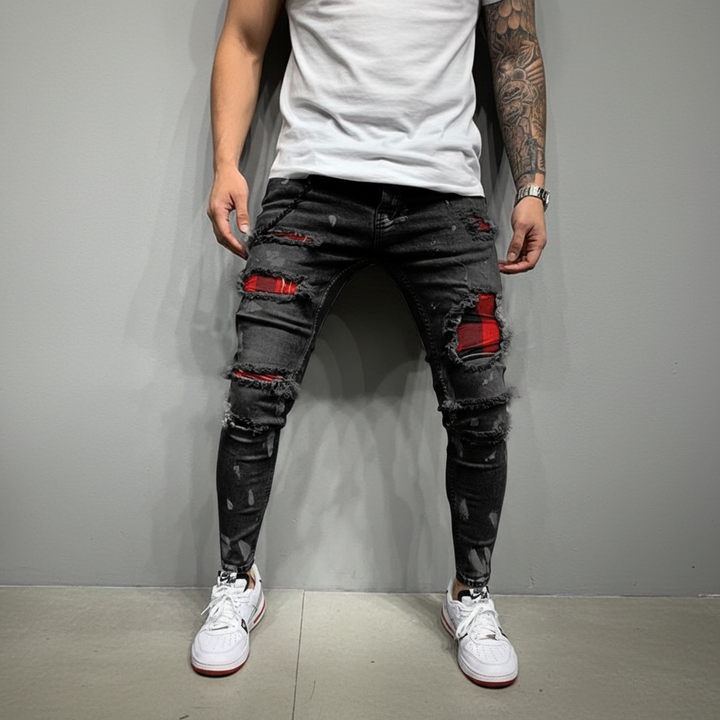 Back view of men's patched ripped jeans, highlighting slim fit, denim texture & pocket details.