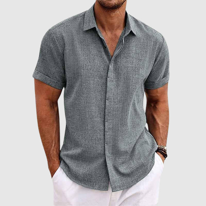 Stylish men's button-down shirt, perfect for beach vacations & casual summer outfits. Relaxed long sleeve.